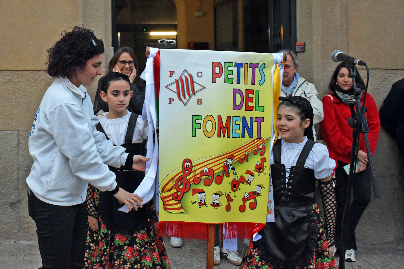 Lliurament de la cinta commemorativa de les Caramelles de SÃºria 2024 a la colla Infantil del Foment Cultural, en lâ€™acte dâ€™inici de la festa al davant de la Casa de la Vila.