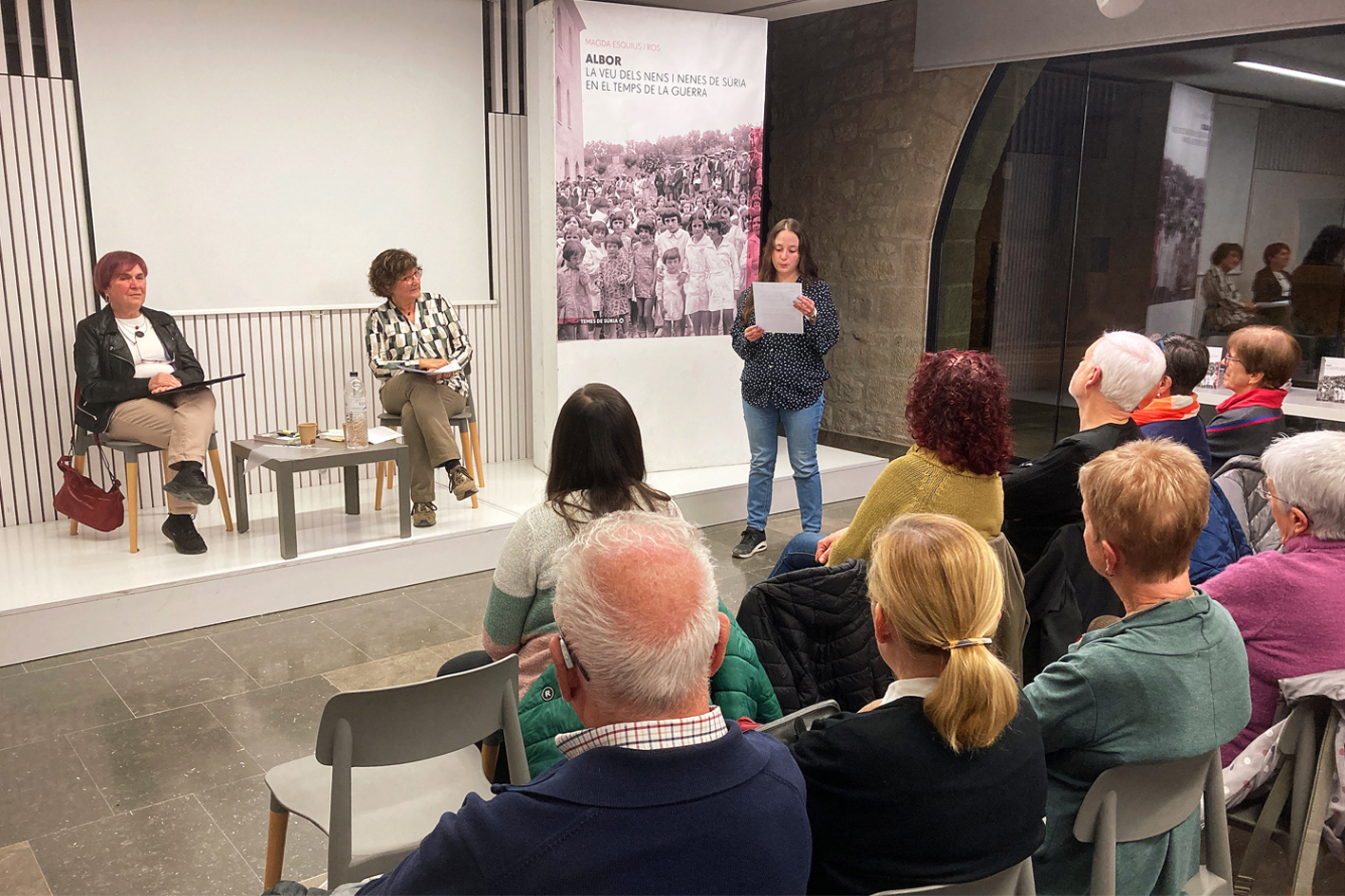 Lectura de textos de la històrica revista escolar surienca Albor, durant l'acte de presentació a Solsona del llibre de Magda Esquius.