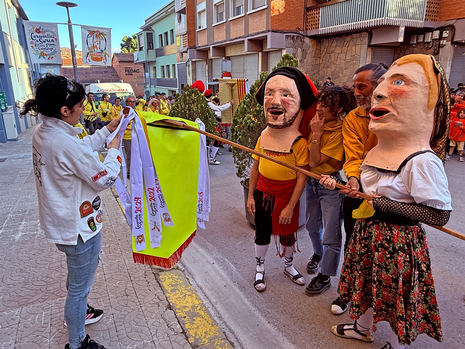 La regidora de Festes, Alba MartÃ­nez, lliura la cinta commemorativa a la colla Juvenil del Foment Cultural en l'acte d'inici de les Caramelles de SÃºria, al davant de la Casa de la Vila.