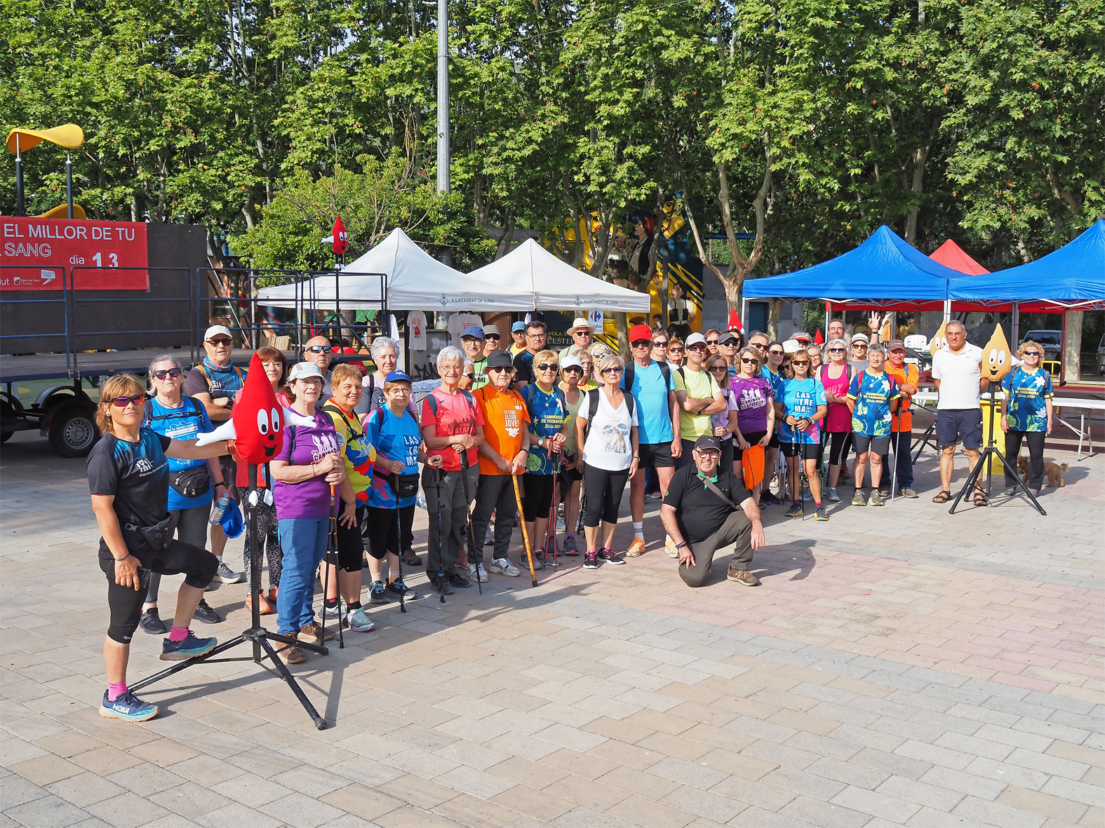 Foto de grup de les persones adultes participants en la caminada de la jornada de donació de sang a la plaça de Sant Joan.