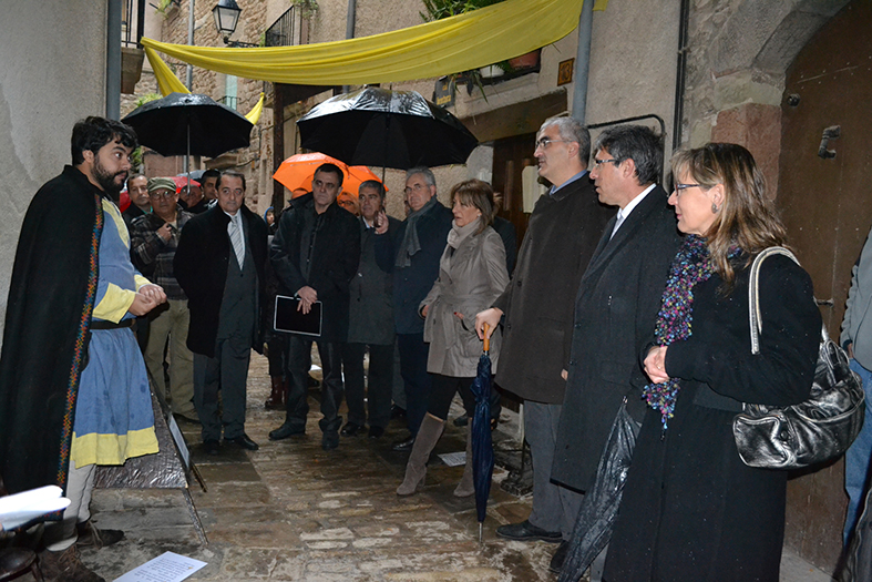 Un personatge de la 12a Fira Medieval dâ€™Oficis de SÃºria explica a les autoritats el funcionament dels estris de la mostra de mÃ quines de tortura i instruments quirÃºrgics - Novembre de 2013.